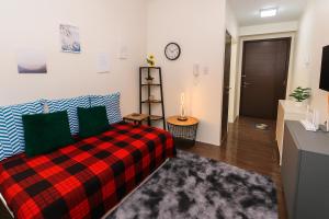 a bedroom with a bed and a clock on the wall at Suite Life Makati Vibes Views Relaxation 3870 in Manila