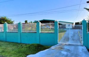 a green gate in front of a house at Favored Haven in Sarava