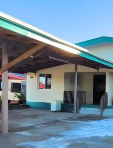 a building with awning and benches in front of it at Favored Haven in Sarava