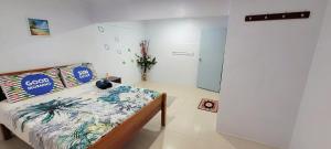 a bedroom with a bed in a room with a wall at Favored Haven in Sarava