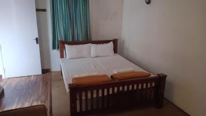 a small bedroom with a bed in a room at Mystical Medows in Ooty