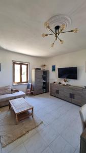 a living room with a couch and a table at Casa al mare con vista sull asinara in Sorso