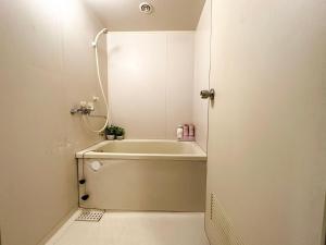 a bathroom with a bath tub and a shower at d402涉谷区域 乘电车4分钟到达新宿 巴士直达涉谷步行到西新宿五丁目8分钟 max6 in Tokyo