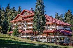 a large apartment building with a red roof at Musala Hotel in Borovets