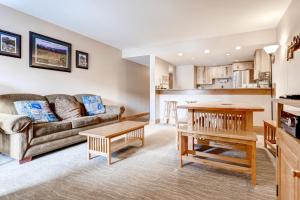 a living room with a couch and a table at Two-Bedroom Mountainside Condo E259 in Frisco