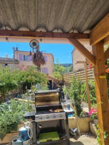 an outdoor grill in the middle of a garden at Le lorrain in Campagne-sur-Aude