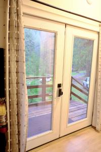 a sliding glass door with a view of a deck at Green Hill at Rainier Lodge (0.4 miles from the entrance) in Ashford