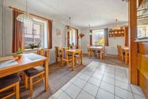 a kitchen and dining room with tables and chairs at Chalupa u Rohlíků in RejÅ¡tejn