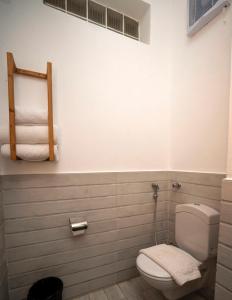 a bathroom with a toilet and towels on a wall at Azad Siwa Hotel in Siwa +23 photos