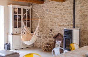 a room with a hammock hanging from a wall at Coudignac 1891 in Lagnes +21 photos