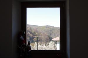 a window in a room with a view of a mountain at Casa vacanza Mariangela in Stregna