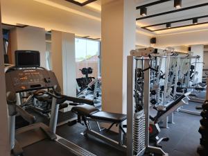 a gym with several tread machines and a treadmill at Azana Style Hotel Tulungagung in Tulungagung
