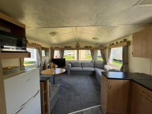 a kitchen and a living room in a caravan at Cabana Escape in Little Clacton