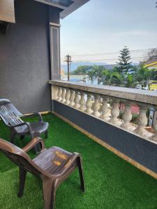 a balcony with chairs and a view of the ocean at Twilight Stays ll VILLA 9PM II SNOOKER TAB II SWIMMING POOL ll AC II BBQ in Lonavala