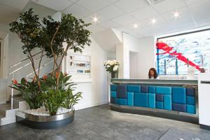 a room with a counter with plants in it at Hôtel Méditerranée in Calvi