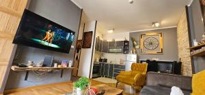 a living room with a flat screen tv on the wall at Center Lux Apartment Marijana in Novi Sad