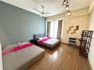 a bedroom with two beds and a chair in it at Saville Cheras 2 Bedroom HomeStay Link MRT in Cheras