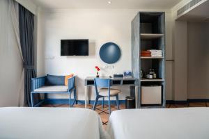 a room with a desk and chairs and a table at Phuket Island View Resort in Karon Beach