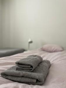 a pile of towels sitting on top of a bed at Harju Apartment in Jyväskylä +3 photos