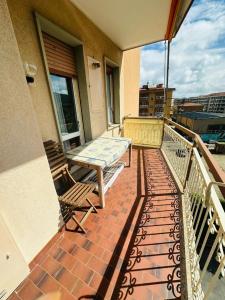 a patio with a table and chairs on a balcony at La casa del mare in Marina dʼAndora +2 photos