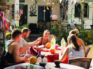 a group of people sitting at a table at Star Rest Arugambay in Arugam Bay