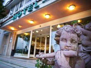 a statue of a child in front of a building at Hotel Begoña Park in Gijón