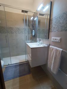 a bathroom with a sink and a shower at Appartamento G&G in San Vito lo Capo +16 photos
