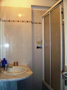 a bathroom with a sink and a shower at Kalimera Hotel in Poros