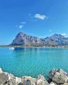 a large body of water with mountains in the background at Appartamento G&G in San Vito lo Capo