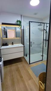 a bathroom with a glass shower and a sink at Rías Baixas Playa Vilariño, Ria de Aldan in Aldán +10 photos