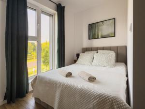 Ένα ή περισσότερα κρεβάτια σε δωμάτιο στο Legnicka Residence 36
