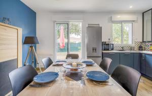 a dining room with a table with blue plates on it at 3 Bedroom Cozy Home In La Tremblade in La Tremblade
