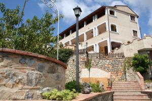 a building with a street light in front of it at Country House B&B Antica Dimora Del Sole in Camerota