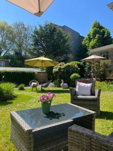 a patio with a table and chairs and an umbrella at Monsieur Michel in Dinant +27 photos