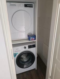 a washer and dryer in a small room at Ferienwohnung Herzberg in Loxstedt +4 photos