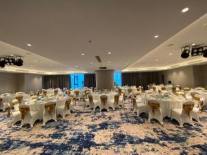 a banquet hall with tables and chairs in a room at A la Carte Ha Long Residences Căn hộ 5 stars cạnh biển in Ha Long +48 photos