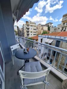 a balcony with a table and chairs on a balcony at La Casa Argentina in Kavala
