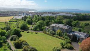 an aerial view of a large house on a green field at Cromore Retreat in Portstewart
