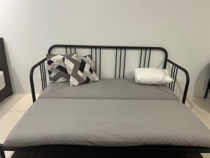 a bed with two pillows on it in a room at LeStarry Homestay in Kuching +15 photos