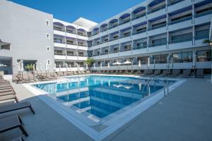 a swimming pool in front of a building at Rhodos Horizon Marina - Adults Only in Rhodes Town