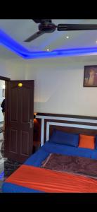 a bedroom with a bed with blue lights on the ceiling at HN cottages, Munnar in Jāmb