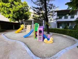 a playground with play equipment in a yard at Phuket Island View Resort in Karon Beach