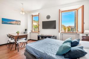 a bedroom with a bed and a table and a desk at FinestraNelBorgo best position Private parking in Portovenere