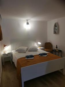 a bedroom with a large bed with two towels on it at Room No stress on Cres in Cres