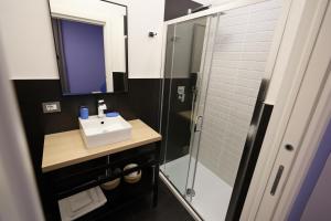 a bathroom with a sink and a shower at Sorelle Misceo in Alberobello