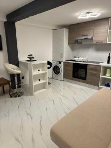 a kitchen with white marble floors and a counter top at Luxury Old Town Rab Studio Apartments in Rab