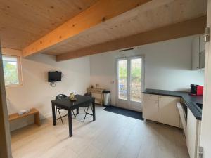 a kitchen with a table and a small table at Logement avec terrasse in Cogolin