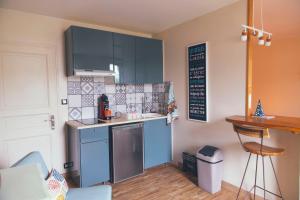a kitchen with blue cabinets and a counter at Studio jangadi in Reignac
