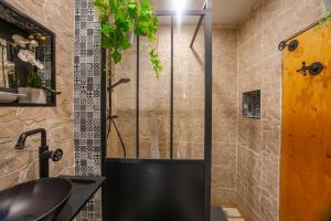a bathroom with a shower with a black sink at Studio tout équipé, plein centre in La Ciotat