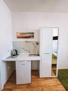 a white desk in a room with a mirror at Dom na Fali Darlowko in Darlowko +69 photos